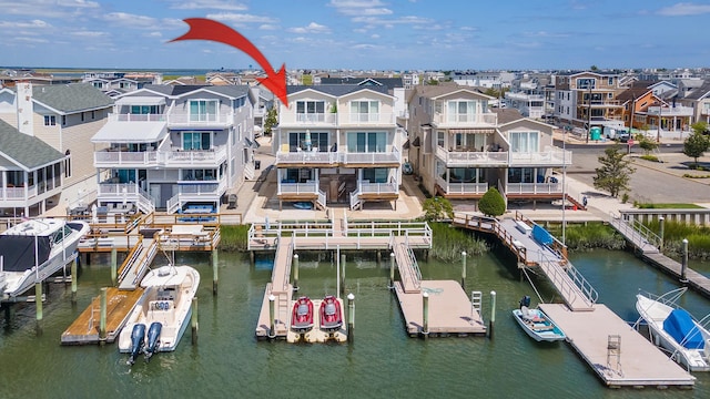 view of dock featuring a water view and a residential view