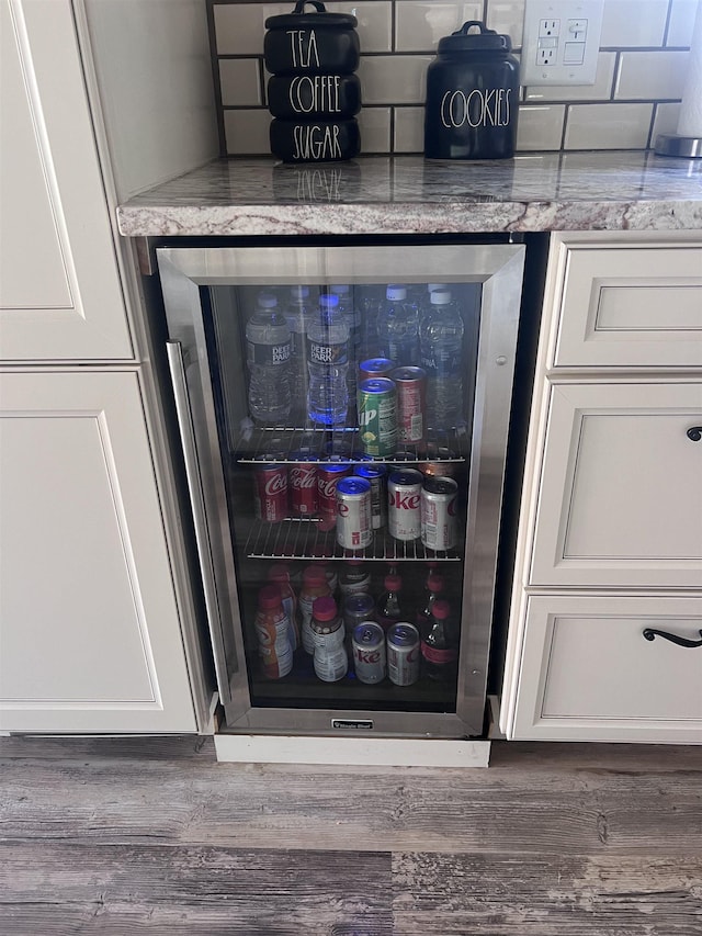 407 Elmwood Ave, Marmora, NJ 08223 - interior details with white cabinets, light stone countertops, and wine cooler