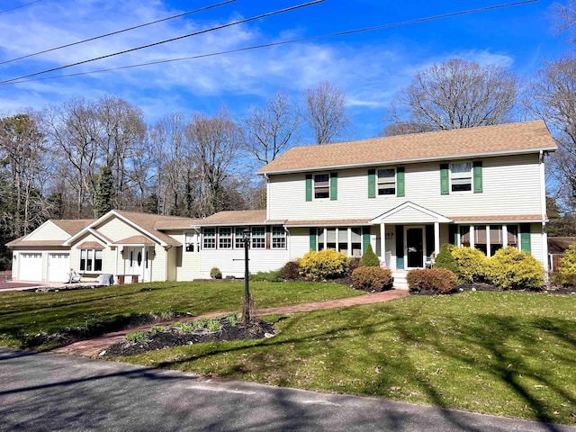 view of front facade with a front yard and a garage