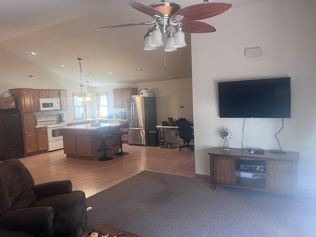407 Elmwood Ave, Marmora, NJ 08223 - living room with light wood-type flooring, vaulted ceiling, and ceiling fan