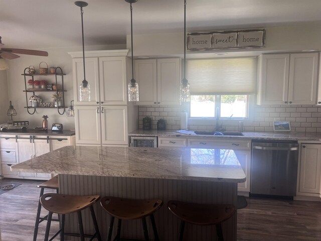 407 Elmwood Ave, Marmora, NJ 08223 - kitchen featuring white cabinets, sink, stainless steel dishwasher, tasteful backsplash, and decorative light fixtures