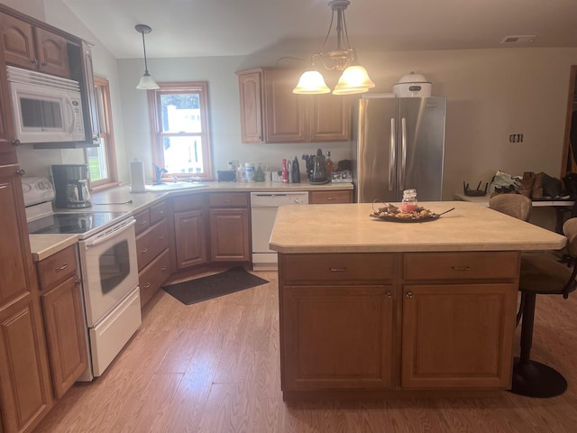 407 Elmwood Ave, Marmora, NJ 08223 - kitchen featuring pendant lighting, a kitchen island, light wood-type flooring, and white appliances