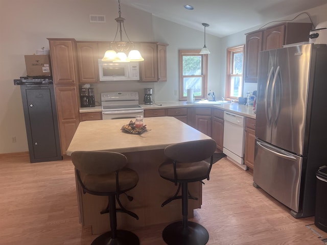 407 Elmwood Ave, Marmora, NJ 08223 - kitchen with a center island, sink, hanging light fixtures, lofted ceiling, and white appliances