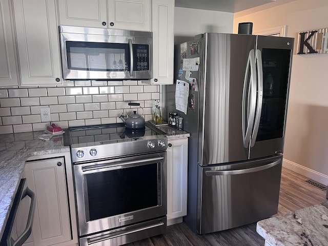 407 Elmwood Ave, Marmora, NJ 08223 - kitchen with white cabinets, dark hardwood / wood-style flooring, light stone counters, and appliances with stainless steel finishes