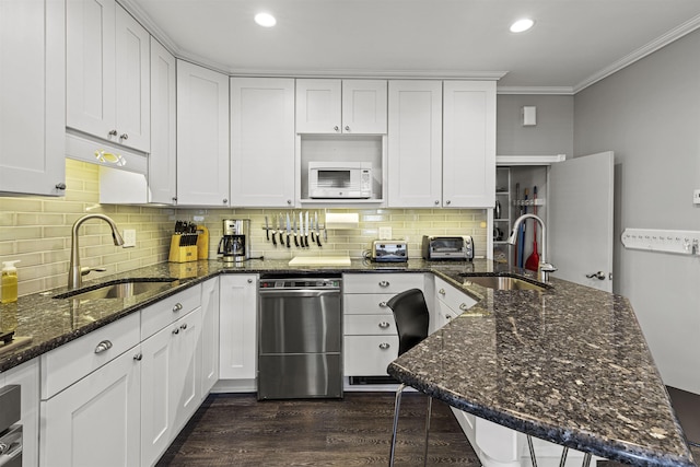 127 Myrtle Ave, West Cape May, NJ 08204 - kitchen featuring dishwasher, white microwave, ornamental molding, a peninsula, and white cabinetry