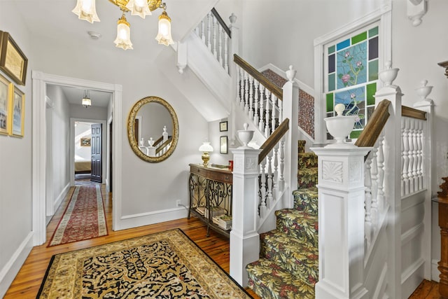 127 Myrtle Ave, West Cape May, NJ 08204 - stairs with wood finished floors, a chandelier, and a high ceiling