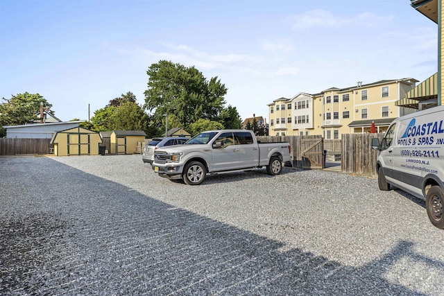127 Myrtle Ave, West Cape May, NJ 08204 - view of car parking featuring a storage shed and a gate
