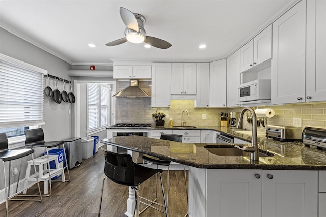 127 Myrtle Ave, West Cape May, NJ 08204 - kitchen featuring wall chimney exhaust hood, white microwave, healthy amount of natural light, white cabinetry, and crown molding