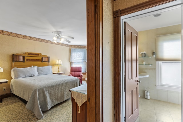 127 Myrtle Ave, West Cape May, NJ 08204 - bedroom with connected bathroom, a ceiling fan, and light tile patterned floors