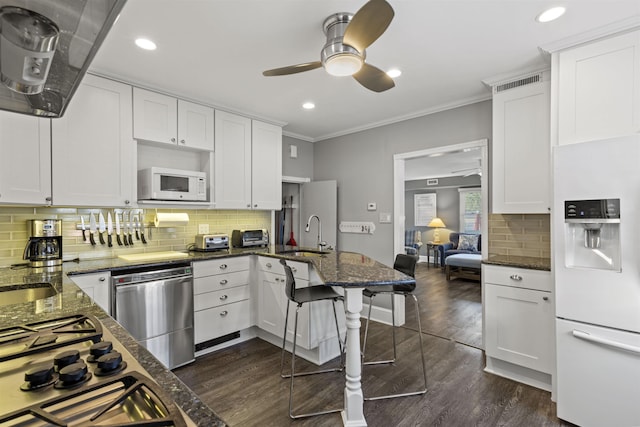 127 Myrtle Ave, West Cape May, NJ 08204 - kitchen featuring stainless steel appliances, a peninsula, a ceiling fan, decorative backsplash, and white cabinetry