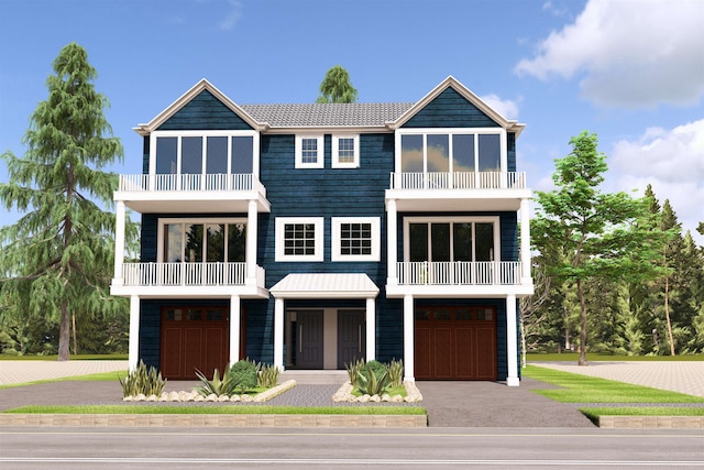 coastal inspired home with a balcony and a garage