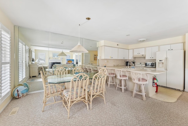 280 79th St Unit 4, Avalon, NJ 08202 - dining area with light carpet and a fireplace