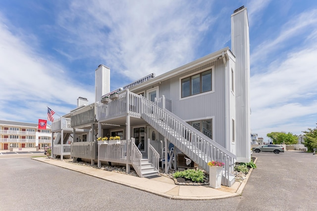 280 79th St Unit 4, Avalon, NJ 08202 - rear view of property with stairway and a chimney