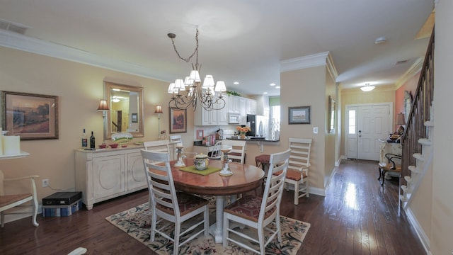 dining room featuring a notable chandelier, dark hardwood / wood-style flooring, and ornamental molding