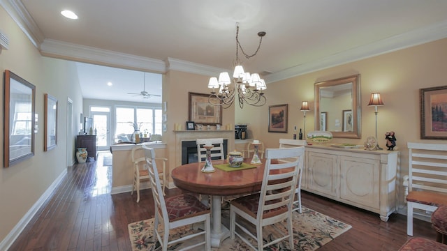 dining space with crown molding, ceiling fan with notable chandelier, and dark hardwood / wood-style floors