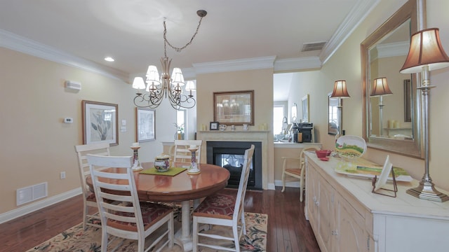 dining room featuring a multi sided fireplace, crown molding, dark hardwood / wood-style floors, and a notable chandelier