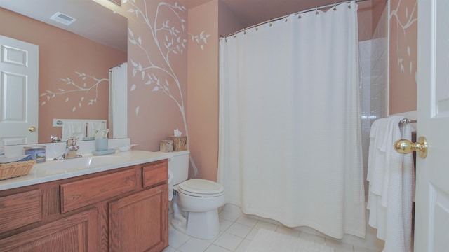 bathroom featuring tile patterned flooring, vanity, and toilet