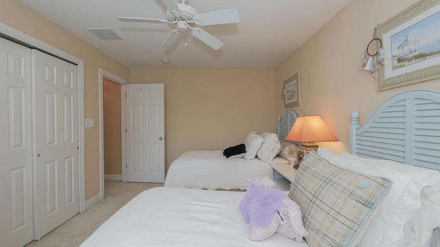 carpeted bedroom featuring ceiling fan and a closet