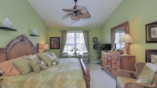 carpeted bedroom with ceiling fan and vaulted ceiling