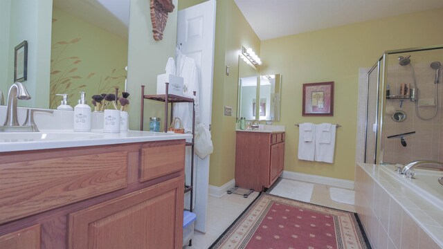 bathroom with tile patterned floors, vanity, and shower with separate bathtub