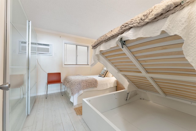 bedroom with crown molding and light wood-type flooring