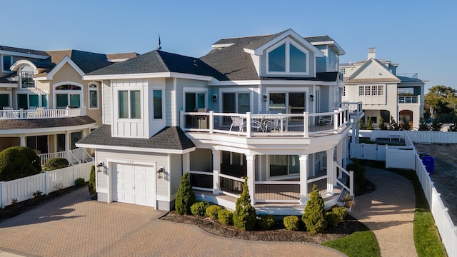 view of front of house with a garage and a balcony