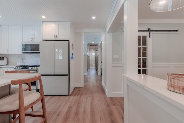 963 Tecumseh Rd, Erma, NJ 08204 - kitchen with appliances with stainless steel finishes, light wood-style flooring, white cabinets, tasteful backsplash, and recessed lighting