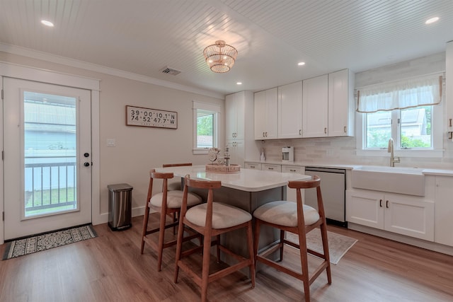 963 Tecumseh Rd, Erma, NJ 08204 - kitchen featuring dishwasher, a sink, a breakfast bar area, white cabinets, and light wood-style flooring