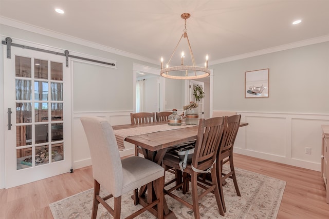 963 Tecumseh Rd, Erma, NJ 08204 - dining space with a decorative wall, a chandelier, light wood-style flooring, ornamental molding, and a barn door