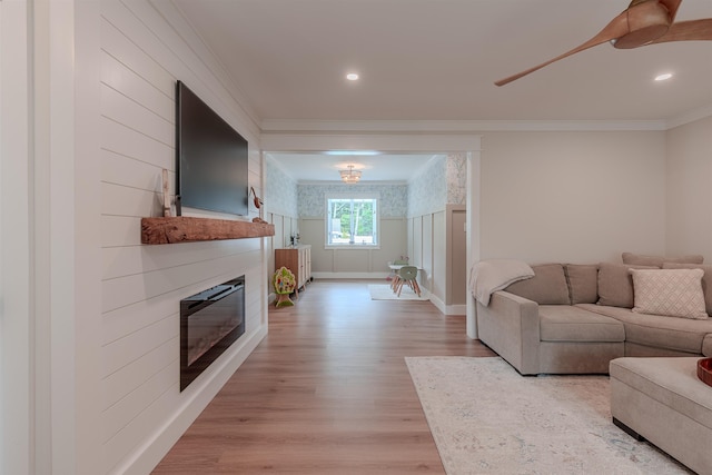 963 Tecumseh Rd, Erma, NJ 08204 - living area with a glass covered fireplace, crown molding, light wood-style floors, baseboards, and ceiling fan