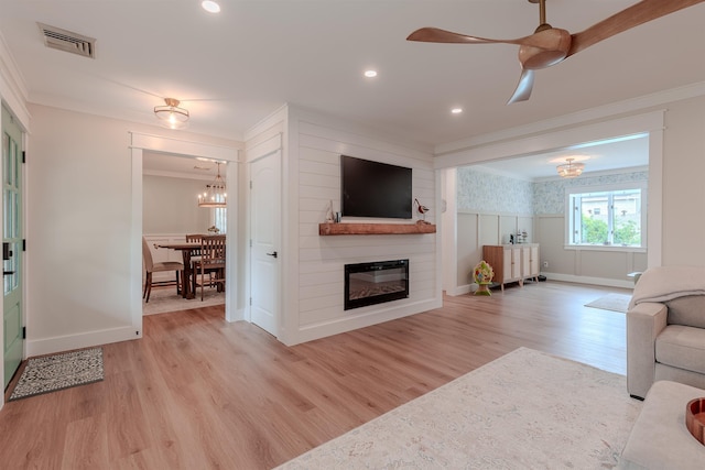 963 Tecumseh Rd, Erma, NJ 08204 - living room featuring crown molding, light wood finished floors, a ceiling fan, a large fireplace, and a chandelier