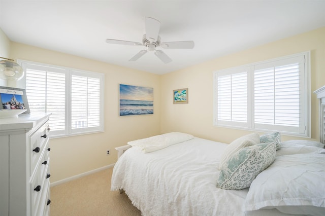 bedroom with ceiling fan and light carpet