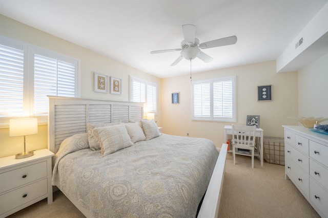 bedroom with ceiling fan and light colored carpet