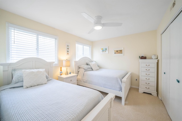 carpeted bedroom featuring a closet and ceiling fan