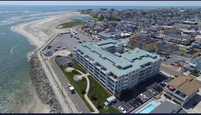 drone / aerial view with a beach view and a water view