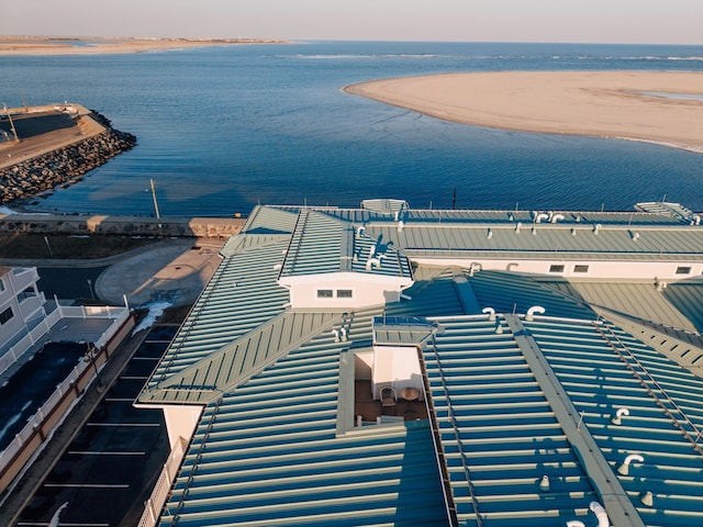 aerial view at dusk featuring a water view