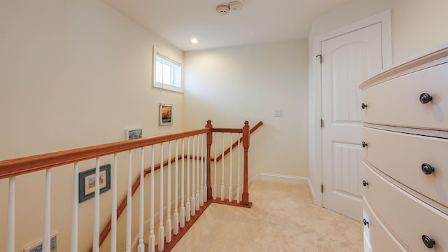 hallway featuring light carpet