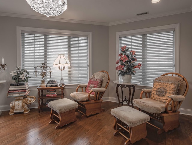 sitting room featuring hardwood / wood-style flooring, a notable chandelier, and crown molding