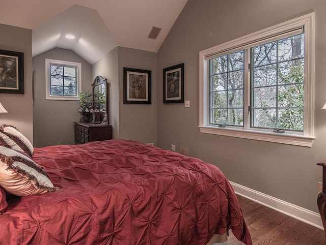 bedroom with dark hardwood / wood-style flooring and lofted ceiling