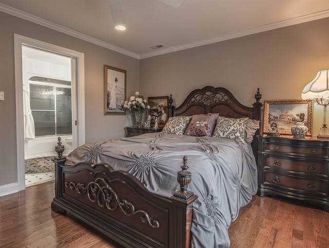 bedroom with hardwood / wood-style floors, crown molding, and ensuite bath