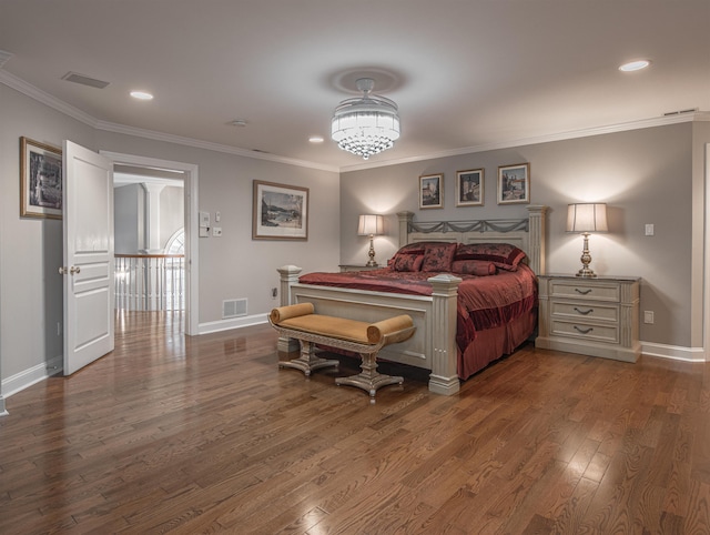 bedroom featuring crown molding and dark wood-type flooring