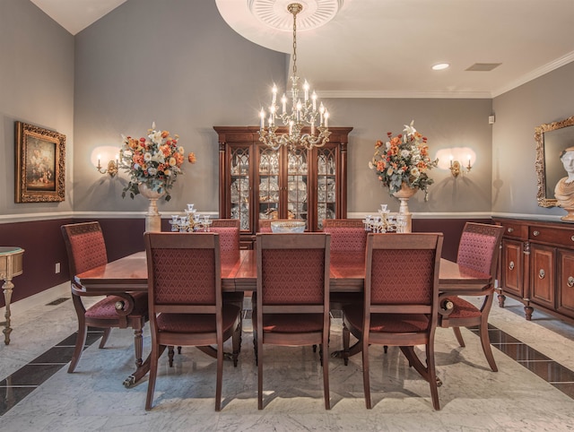 dining space featuring crown molding and a chandelier