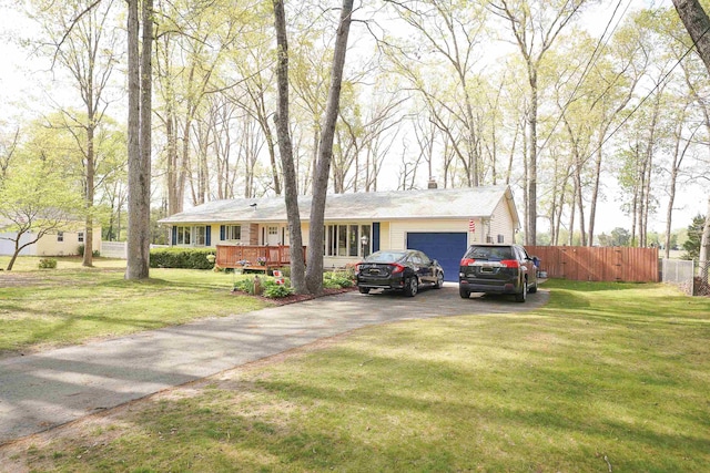 ranch-style house with driveway, fence, an attached garage, a front yard, and a wooden deck