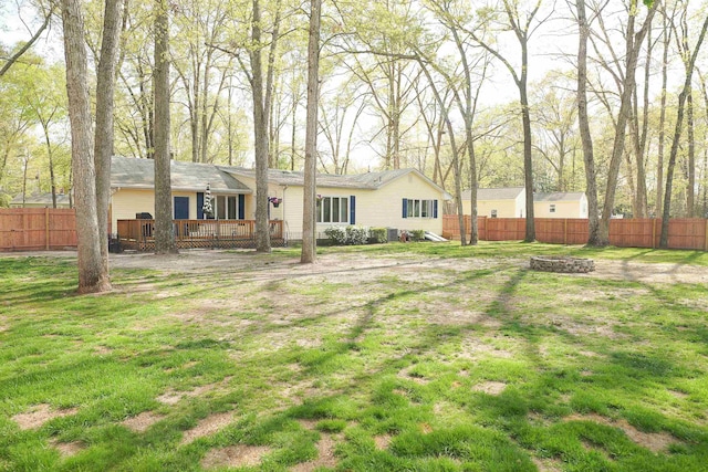 view of yard featuring a fire pit, fence, and a wooden deck