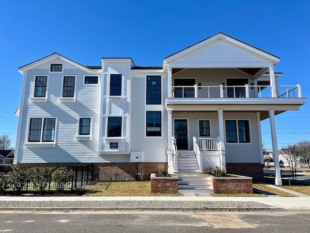 view of front facade featuring covered porch and a balcony