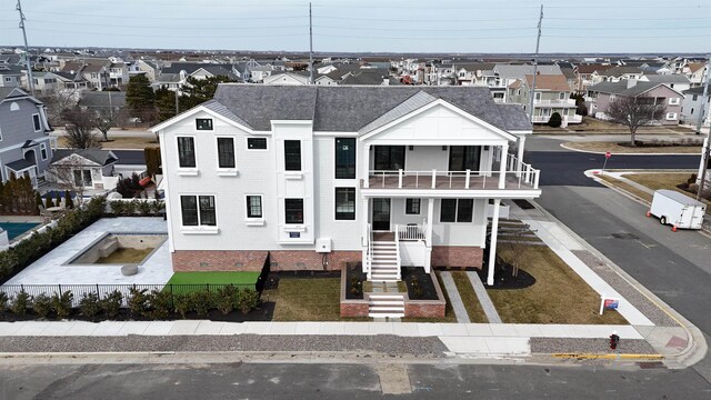 view of front of home featuring a balcony