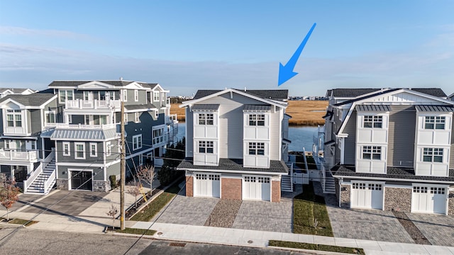 view of front of house featuring a water view and a garage