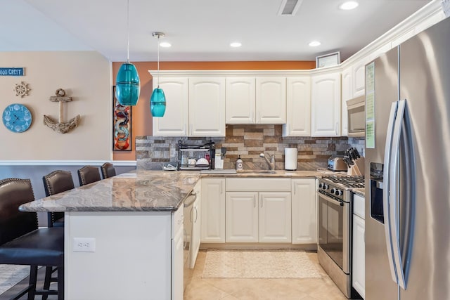 415 E Heather Rd Unit 202, Wildwood Crest, NJ 08260 - kitchen featuring stainless steel appliances, a peninsula, a kitchen breakfast bar, a sink, and light stone countertops