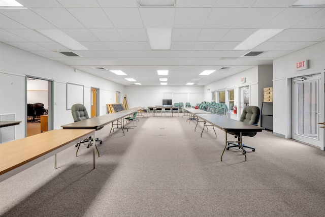 interior space with a paneled ceiling