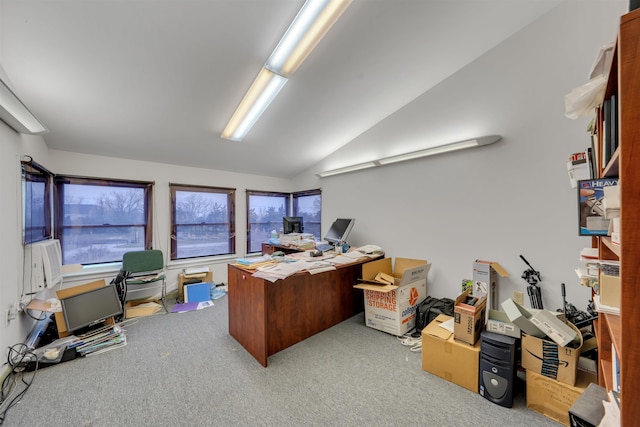 carpeted home office featuring lofted ceiling